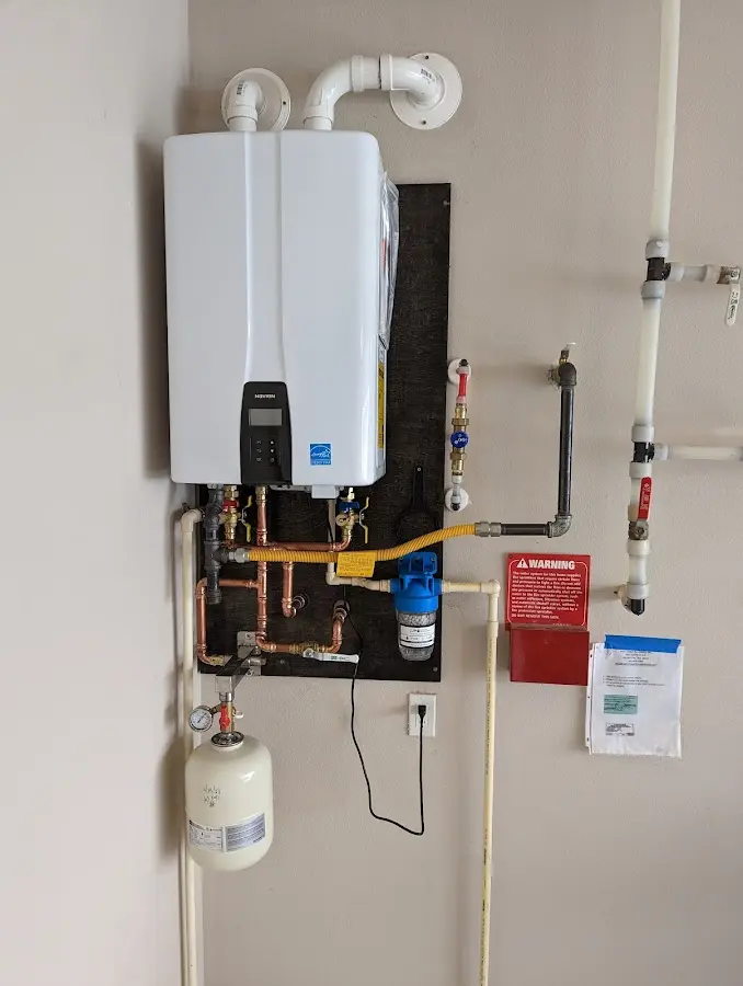 Professional plumber installing copper piping in a Neptune Beach home